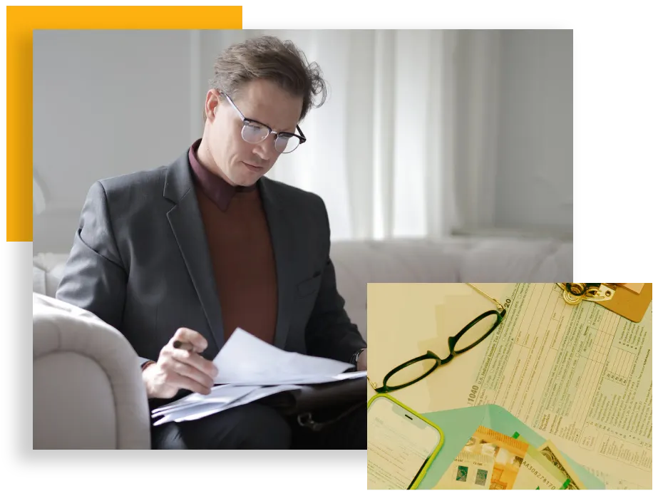 A man sitting on the couch writing in his notebook.